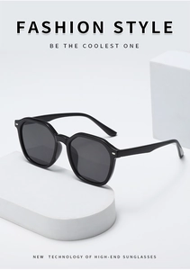 Macro detail of high-end black hexagonal sunglasses with silver metallic hinge accents
