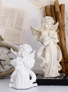 Detail of vintage angel figurines with intricate textures and elegant European resin carving