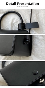 Close-up of black leather handbag featuring round handles and fine stitching details