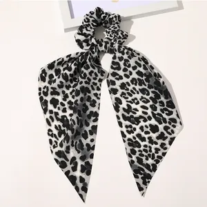 Detailed view of leopard print satin hair scrunchie with elegant long ribbon streamers