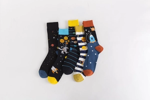 Detailed flat lay of five cotton socks featuring colorful space astronaut and rocket patterns