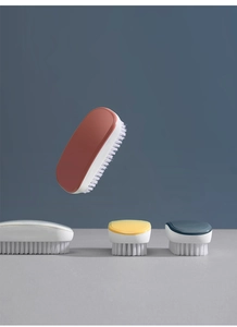 Creative composition of multi-colored laundry brushes with stiff white bristles