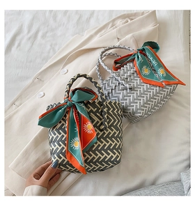 Close-up of woven tote bags with geometric patterns and colorful silk scarf details