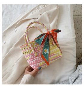 Detail of colorful woven tote bag featuring a decorative printed floral silk scarf