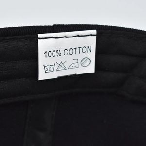 Detail showing the 100% cotton material label and inner stitching of the baseball cap