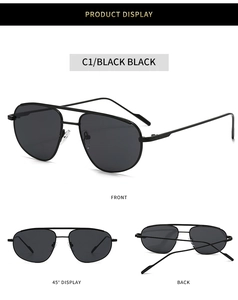 Detail of pilot-style sunglasses with black metal double bridge and dark lenses