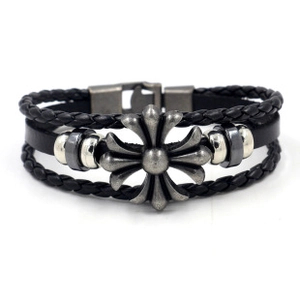 Detail van zwarte meerlaagse leren armband met antiek zilveren kruis en metalen kralen