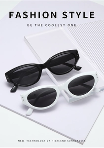 Detailed view of vintage cat eye sunglasses in black and white with silver rivet accents