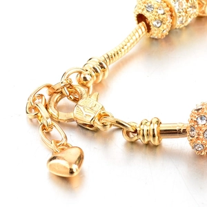Detailed macro view of the gold lobster clasp and extension chain on the heart snake bracelet