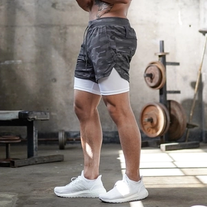 Detail of men's 2-in-1 sports shorts with camouflage shell and white compression liner