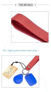Detail of red leather wrist strap with silver rivets and blue RFID key fob accessory