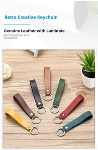 Detail view of colorful genuine leather keychains with vintage metal rings on wood