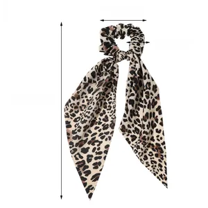 Detail view of leopard print satin hair tie scarf showing 36cm length and 9cm width dimensions
