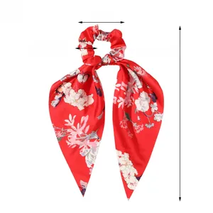 Detailed view of red floral satin scrunchie with 37cm long ribbon streamers and 9cm diameter