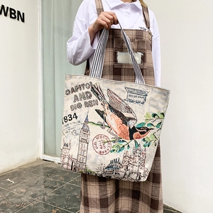 Detail of canvas tote bag featuring vintage Big Ben print and striped shoulder straps