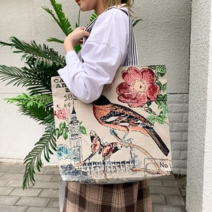 Detail of canvas tote bag with floral bird patterns and Big Ben jacquard embroidery