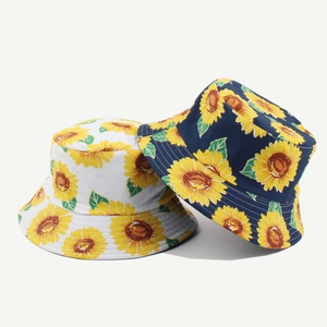Detail of white and navy reversible bucket hats with sunflower prints on cotton fabric