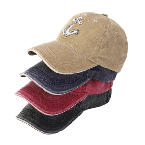 Detail of anchors embroidered on washed cotton baseball caps in multiple colors