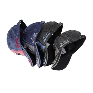 Detail of four washed cotton baseball caps with side embroidery and metal buckles