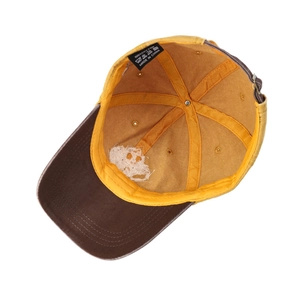 Inside view of a two-tone cotton baseball cap with yellow crown and brown brim