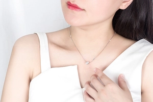 Delicate S925 sterling silver chain necklace with a sparkling round zircon pendant on model