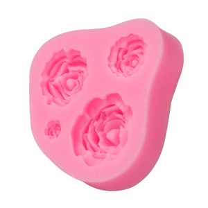 Pink silicone mold featuring three detailed rose flower designs for fondant and chocolate