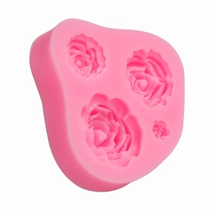 Pink silicone mold featuring four detailed rose flower patterns for DIY cake baking