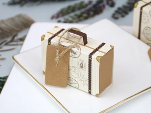 Macro detail of vintage mini suitcase wedding favor box with retro stamps and twine