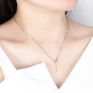 Close-up of a minimalist S925 sterling silver Y-shaped necklace on model's neckline