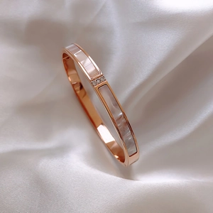 Elegant rose gold stainless steel bracelet with white shell inlay and sparkling rhinestones