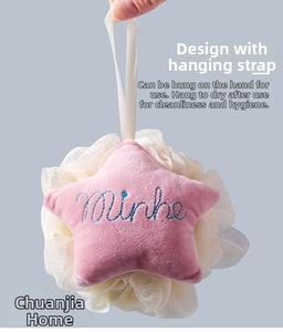 Star-shaped pink plush bath sponge with blue embroidery and white mesh, shown hanging