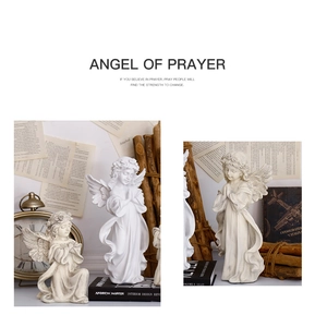 Detailed close-up of intricate feather textures on resin prayer angel sculptures