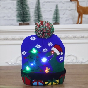 Blue knitted Christmas hat with LED lights featuring dinosaur and tree patterns