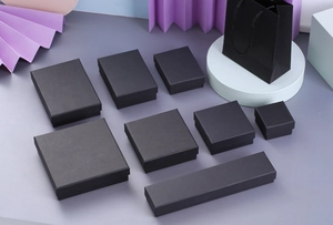 Detailed set of black kraft paper jewelry boxes and gift bags in various sizes