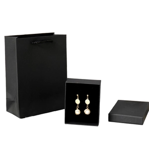 Golden pearl earrings set with elegant black gift box and matching carrier bag