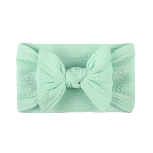 Soft jacquard nylon baby headband with large mint green bow and stretchy knit pattern