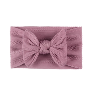 Detail of dusty pink cable knit nylon headband with soft jacquard bow for baby girls