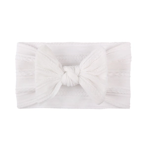 Soft white cable knit baby headband with a large bow for infants and toddlers