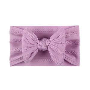 Detailed knit texture of lavender nylon baby headband with a large decorative bow