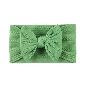 Soft grass green jacquard nylon baby headband with a large bow for infants and toddlers