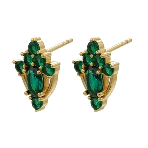 Macro shot of gold vintage earrings featuring micro-set emerald green zircon stones
