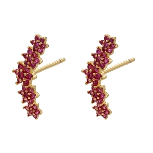 Close-up of gold flower earrings with micro-paved red zircon crystals in a curved design
