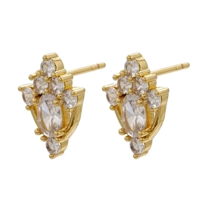 Macro shot of gold-plated geometric stud earrings with sparkling zircon gemstones