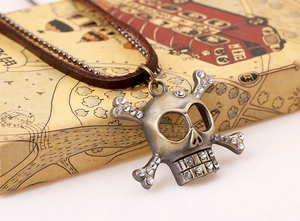 Detailed macro view of vintage bronze skull pendant with rhinestones on double layer chain