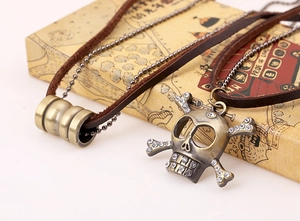 Detail of vintage multilayer skull pendant necklace with crystal accents and leather cords