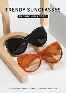 Detail view of large round sunglasses featuring unique horizontal ribbed texture on wide temples