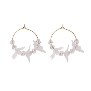 Detail of white matte petal earrings with gold metal hooks and transparent beads