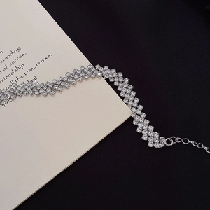 Detailed macro view of sparkling multi-row silver rhinestone choker with adjustable chain