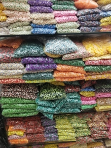 Bulk polymer clay fruit and star beads for DIY jewelry making in warehouse storage