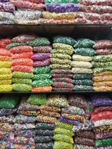 Close-up of mixed colorful fruit and flower polymer clay beads for DIY jewelry making